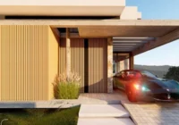 Fachada moderna com garagem e carro esportivo — casa