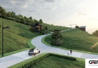 Rua pavimentada do condomínio com área verde — Condomínio Pôr do Sol